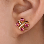 Tiffany Schlumberger gold stud earrings—iconic "X" motif crossover button-style studs.