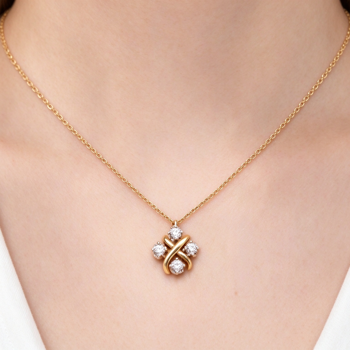 Tiffany & Co. Schlumberger Sixteen Stone X pendant necklace in yellow gold.
