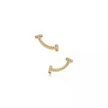 Tiffany T Smile earrings, yellow gold | Luxurious curved stud earrings, women's fine jewelry