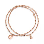 Tiffany gold wrap necklace—double-strand chain featuring signature spheres and a lock pendant.