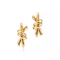 Tiffany Knot Small Gold Earrings—Hand-polished stud earrings featuring the signature organic knot design | Minimalist luxury gold jewelry